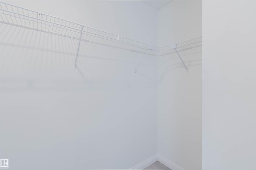 White wire shelving installed in an alcove with light-colored walls and baseboards - 13755 131B Avenue, Edmonton, AB - Indoor With Storage