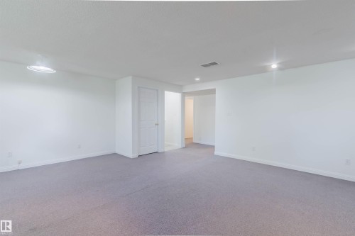 Spacious room featuring light gray carpeting, white walls, and recessed lighting - 13755 131B Avenue, Edmonton, AB - Indoor Photo Showing Other Room