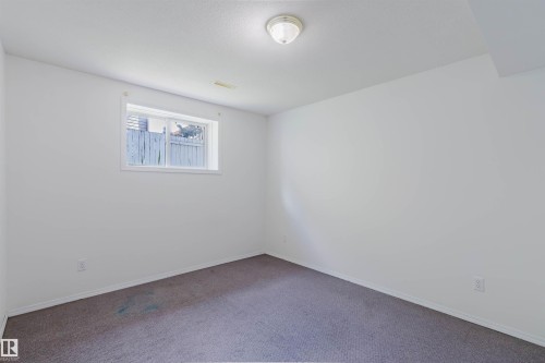 Carpeted room featuring a single window, white painted walls, and a flush-mount ceiling light - 13755 131B Avenue, Edmonton, AB - Indoor Photo Showing Other Room