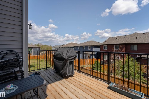 Exterior wood deck featuring black metal railings and direct access to a fenced backyard - 5323 Lark Landing Landing, Edmonton, AB - Outdoor With Deck Patio Veranda With Exterior