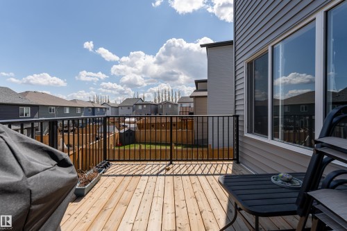 Expansive outdoor deck featuring natural wood flooring and black metal railings - 5323 Lark Landing Landing, Edmonton, AB - Outdoor With Deck Patio Veranda With Exterior