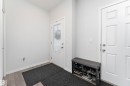 Entryway featuring light gray walls, wood-finish flooring, a paneled door with frosted glass insert, and a separate paneled interior door - 5323 Lark Landing Landing, Edmonton, AB  - Indoor Photo Showing Other Room 