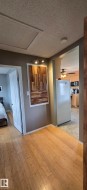 Honey-toned wood-finish flooring extending from the entryway - 