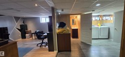 Finished basement with wood-finish flooring and recessed lighting - 