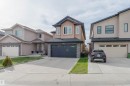 Contemporary two-story residence with a tan stucco exterior and stone veneer accents - 17030 62 Street, Edmonton, AB  - Outdoor With Facade 