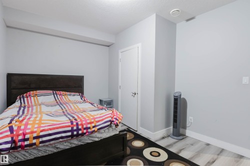 Spacious room featuring light gray walls and wood-finish flooring - 17030 62 Street, Edmonton, AB - Indoor Photo Showing Bedroom