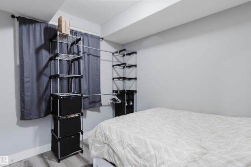 Light gray walls with wood-finish flooring - 17030 62 Street, Edmonton, AB - Indoor Photo Showing Bedroom