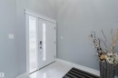 Entryway featuring a white door with a frosted glass panel and a bright white tile floor - 17030 62 Street, Edmonton, AB  - Indoor Photo Showing Other Room 