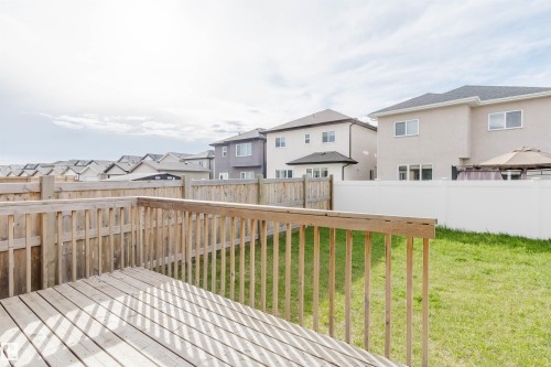 Outdoor deck with natural wood construction and slatted railing overlooking a grassy yard - 17030 62 Street, Edmonton, AB - Outdoor With Deck Patio Veranda With Exterior
