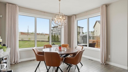 Dining area with large windows providing ample natural light - 2620 Adam Crest, Edmonton, AB - Indoor Photo Showing Dining Room