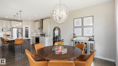 Open-concept kitchen and dining area featuring dark wood-finish flooring - 2620 Adam Crest, Edmonton, AB - Indoor Photo Showing Dining Room