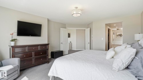 Carpeted bedroom featuring neutral wall tones, a recessed ceiling, and a decorative semi-flush mount light fixture - 2620 Adam Crest, Edmonton, AB - Indoor Photo Showing Bedroom