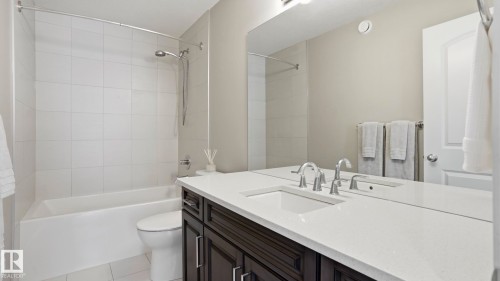 White tile flooring paired with a white tub and shower surround - 2620 Adam Crest, Edmonton, AB - Indoor Photo Showing Bathroom