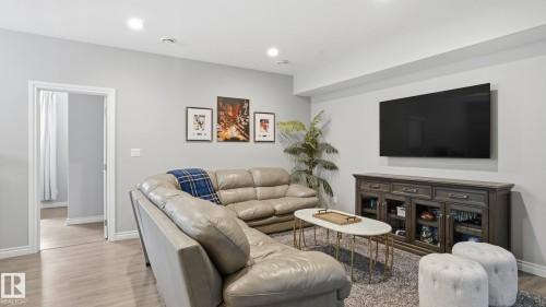 Open living area featuring wood-finish flooring, recessed lighting, and a neutral wall color palette - 2620 Adam Crest, Edmonton, AB - Indoor Photo Showing Living Room