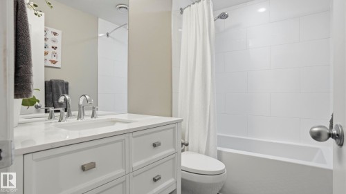 Bathroom featuring a white vanity with an undermount sink, chrome fixtures, and a white countertop - 2620 Adam Crest, Edmonton, AB - Indoor Photo Showing Bathroom