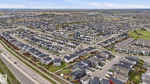 Aerial perspective showcasing a residential community with a mix of single-family homes and multi-unit buildings - 2620 Adam Crest, Edmonton, AB - Outdoor With View
