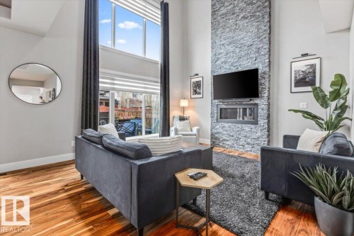 Soaring ceilings with extensive window features - 219 Cranberry Bend, Fort Saskatchewan, AB - Indoor With Fireplace