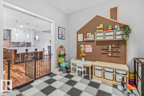 Dedicated play area featuring checkerboard-patterned flooring - 219 Cranberry Bend, Fort Saskatchewan, AB - Indoor Photo Showing Other Room