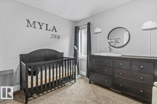 Carpeted room with light gray walls - 219 Cranberry Bend, Fort Saskatchewan, AB - Indoor Photo Showing Bedroom