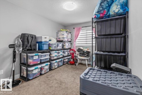 Neutral gray walls and a textured carpeted floor - 219 Cranberry Bend, Fort Saskatchewan, AB - Indoor Photo Showing Bedroom