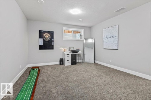 Spacious room featuring plush gray carpeting, light gray walls, and white trim - 219 Cranberry Bend, Fort Saskatchewan, AB - Indoor