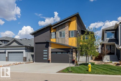 Contemporary architecture featuring multiple exterior finishes, an attached two-car garage, and a concrete driveway - 219 Cranberry Bend, Fort Saskatchewan, AB - Outdoor With Facade