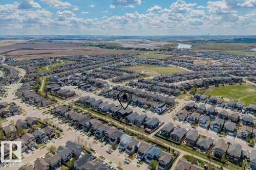 Aerial perspective showcasing a residential development with a mix of two-story and single-story homes - 219 Cranberry Bend, Fort Saskatchewan, AB - Outdoor With View
