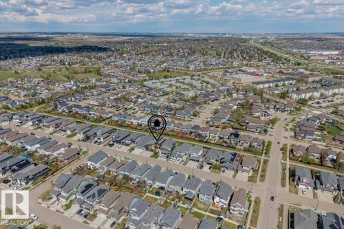 Aerial perspective showcasing a residential area with a prominent pinpoint marker indicating a specific property - 219 Cranberry Bend, Fort Saskatchewan, AB - Outdoor With View