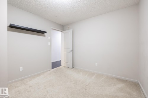 Neutral-toned wall paint and light-colored carpeting - 131 344 Windermere Road, Edmonton, AB - Indoor Photo Showing Other Room