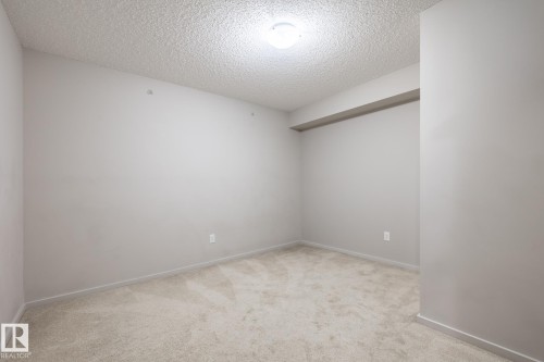 Carpeted room with light gray walls, textured ceiling, recessed ceiling fixture, and baseboard trim - 131 344 Windermere Road, Edmonton, AB - Indoor Photo Showing Other Room