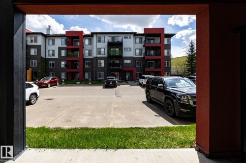Contemporary multifamily building with multi-toned facade, private balconies, and a surface parking area - 131 344 Windermere Road, Edmonton, AB - Outdoor With Facade