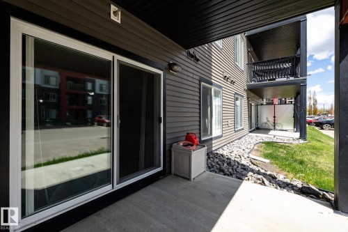 Ground-level patio with a concrete surface and dark siding exterior - 131 344 Windermere Road, Edmonton, AB - Outdoor With Exterior