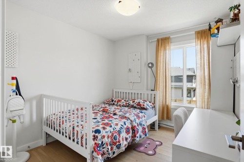 Bright room featuring light wood-finish flooring and white painted walls - 2116 159 Street, Edmonton, AB - Indoor Photo Showing Bedroom