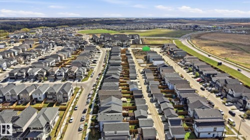 Developed residential neighborhood featuring uniform single-family homes with dark roofs and light-colored siding - 2116 159 Street, Edmonton, AB - Outdoor With View
