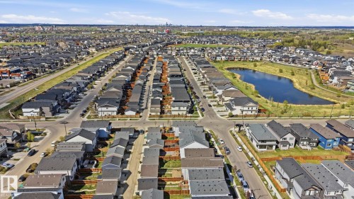 Developed residential neighborhood featuring single-family homes with varied exterior finishes and black shingle roofs - 2116 159 Street, Edmonton, AB - Outdoor With View