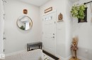 Entryway featuring a white paneled door with glass inserts, light neutral wall paint, and light wood-finish flooring - 2116 159 Street, Edmonton, AB  - Indoor Photo Showing Other Room 