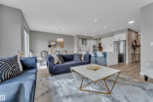 The living area features light-colored walls and flooring, with recessed lighting - 21853 98A Avenue, Edmonton, AB - Indoor Photo Showing Living Room
