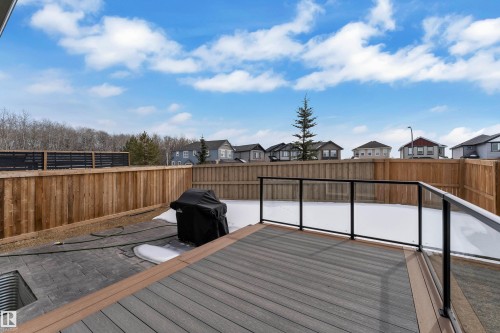 The property features a private backyard with a wood fence and a composite deck with glass railings - 21853 98A Avenue, Edmonton, AB - Outdoor With Deck Patio Veranda