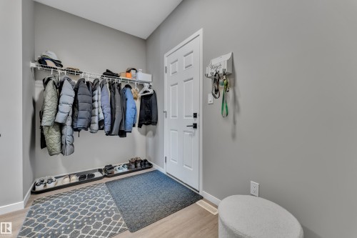 Entryway featuring light grey walls, a white door with black hardware, and light-toned flooring - 21853 98A Avenue, Edmonton, AB - Indoor