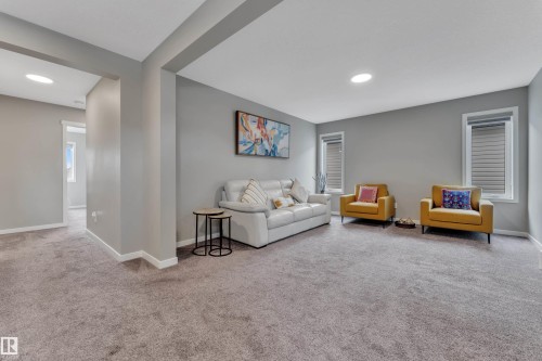Spacious room featuring light grey walls, recessed ceiling lighting, and grey carpeting - 21853 98A Avenue, Edmonton, AB - Indoor