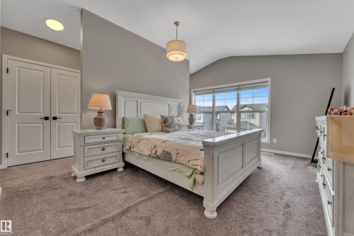 This property features a bedroom with a vaulted ceiling, a neutral color palette, and carpeted flooring - 21853 98A Avenue, Edmonton, AB - Indoor Photo Showing Bedroom