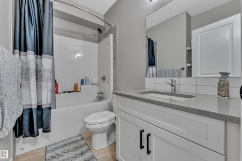 Bathroom featuring a white vanity with a light gray countertop, an integrated sink, and a large mirror - 21853 98A Avenue, Edmonton, AB - Indoor Photo Showing Bathroom
