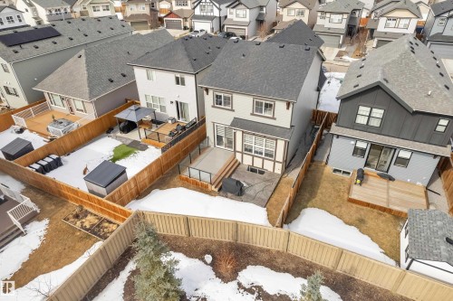 The property features a fenced backyard with a raised deck, a patio area, and sections of artificial turf - 21853 98A Avenue, Edmonton, AB - Outdoor With Deck Patio Veranda