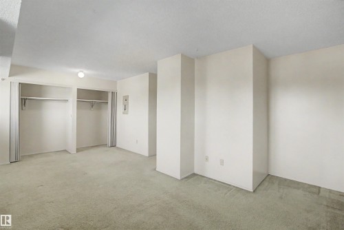 Spacious room featuring light-colored carpeting, white walls, and a ceiling-mounted light fixture - 5953 40 Avenue, Edmonton, AB - Indoor Photo Showing Other Room