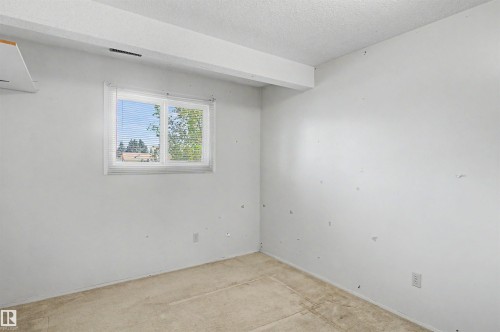 Room featuring a window with horizontal blinds, providing natural light - 5953 40 Avenue, Edmonton, AB - Indoor Photo Showing Other Room