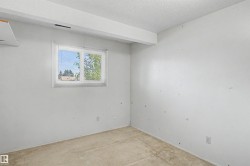 Room featuring a window with horizontal blinds, providing natural light - 