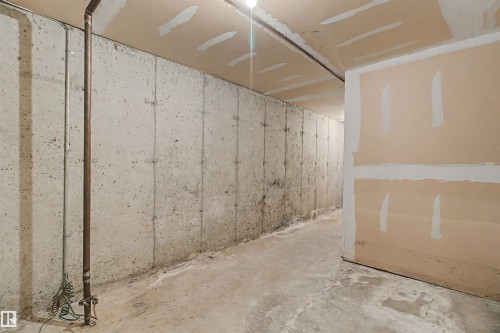 Unfinished concrete walls and flooring with partial drywall installation - 5953 40 Avenue, Edmonton, AB - Indoor