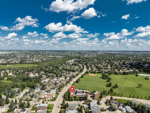 Aerial perspective showcasing the surrounding residential landscape and expansive green spaces - 5953 40 Avenue, Edmonton, AB 