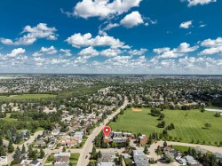Aerial perspective showcasing the surrounding residential landscape and expansive green spaces - 