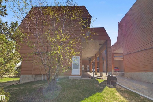 Brown horizontal siding exterior with a white entry door - 5953 40 Avenue, Edmonton, AB - Outdoor